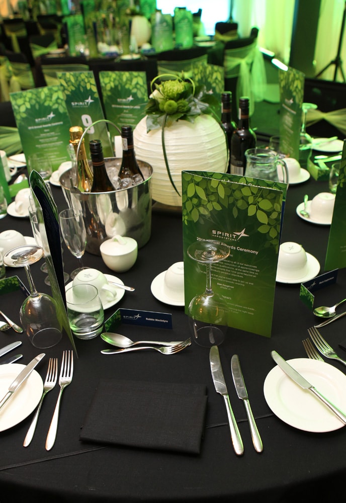 Stunning corporate event set design, lighting and sound production in grand marquee 3 Design of table theme, programmes and table centre piece