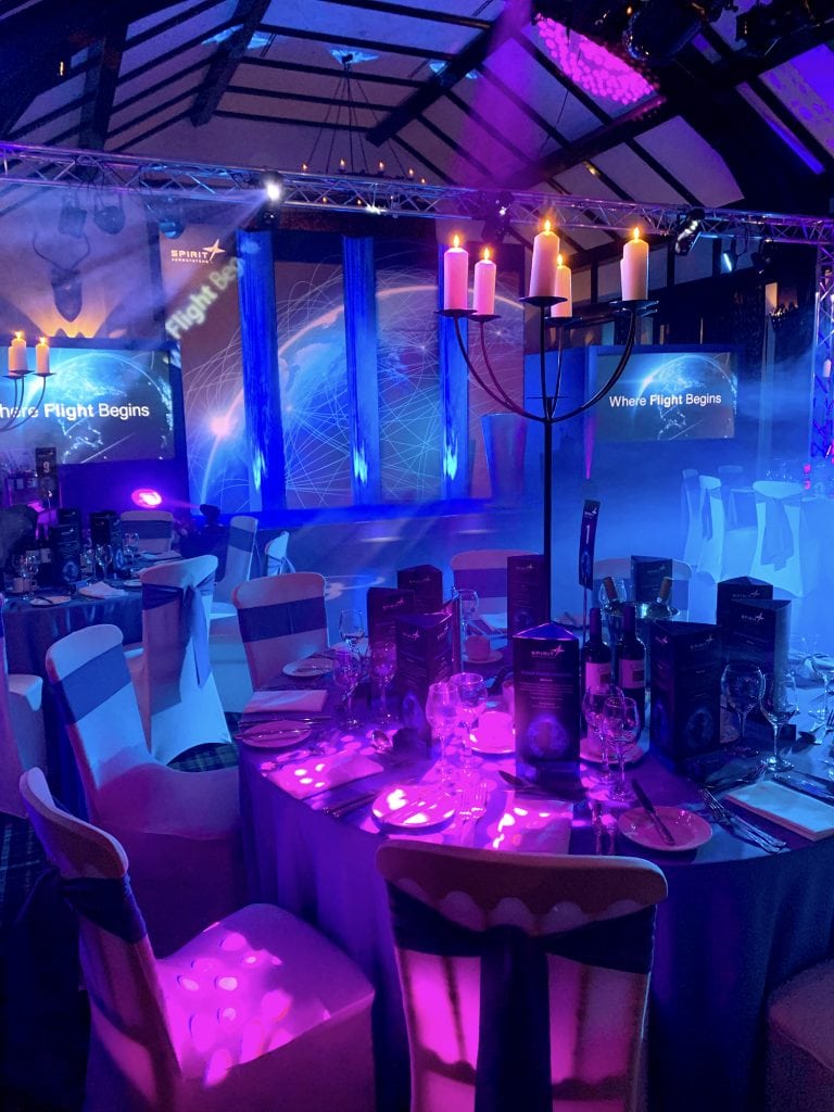 Atmospheric creative lighting effects that fills the corporate event venue with cyan and magenta lighting effects