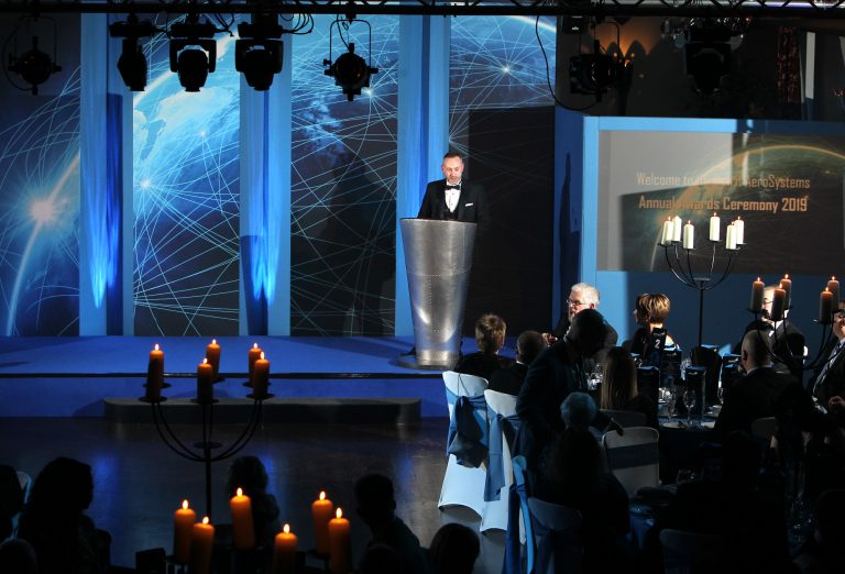 Custom built stage, set graphic panel design in blue 'global success' theme and aviation themed lectern